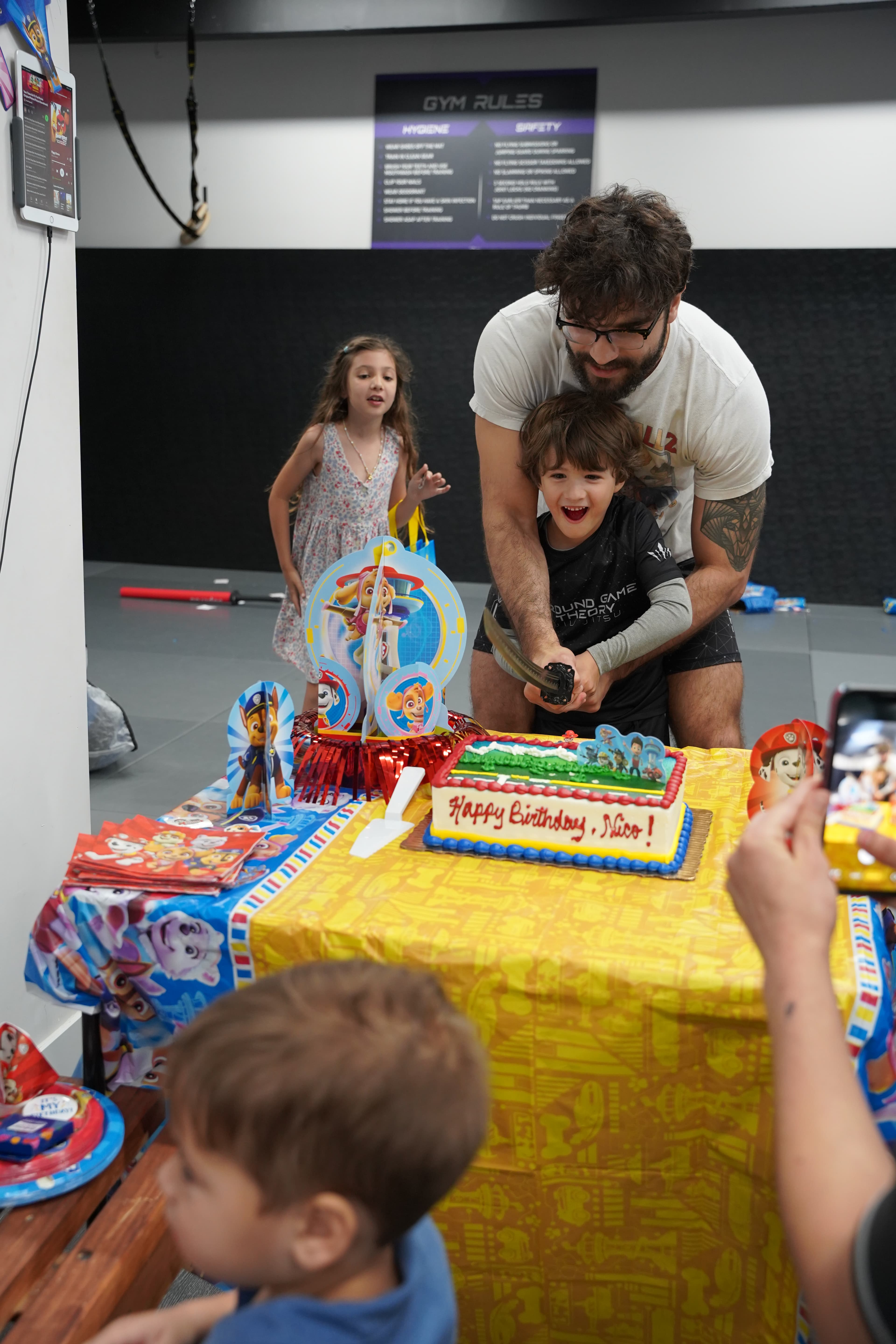 Birthday child cutting cake with samurai sword at Ground Game Theory Miami