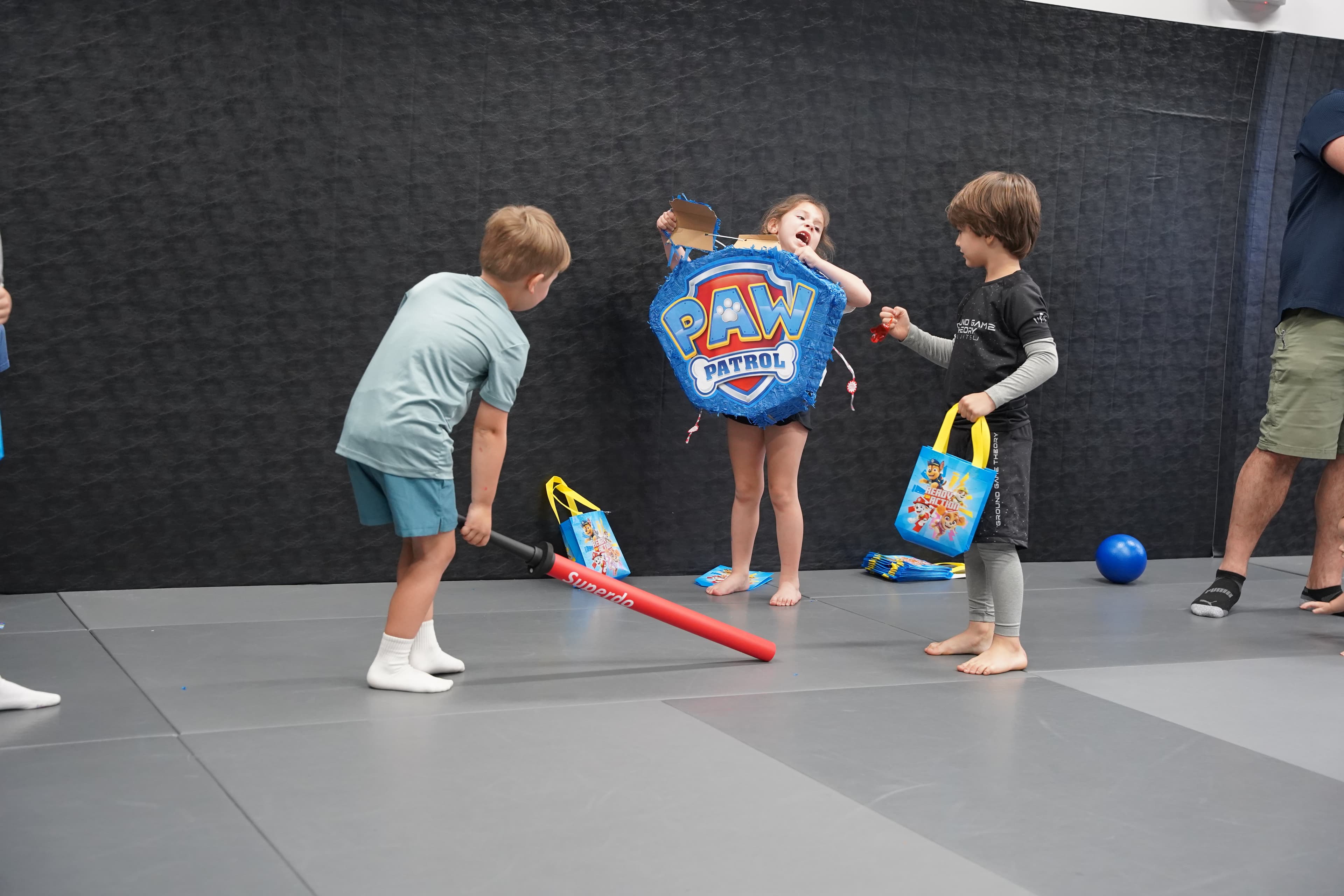 Kids playing foam sword battles at a birthday party at Ground Game Theory Miami