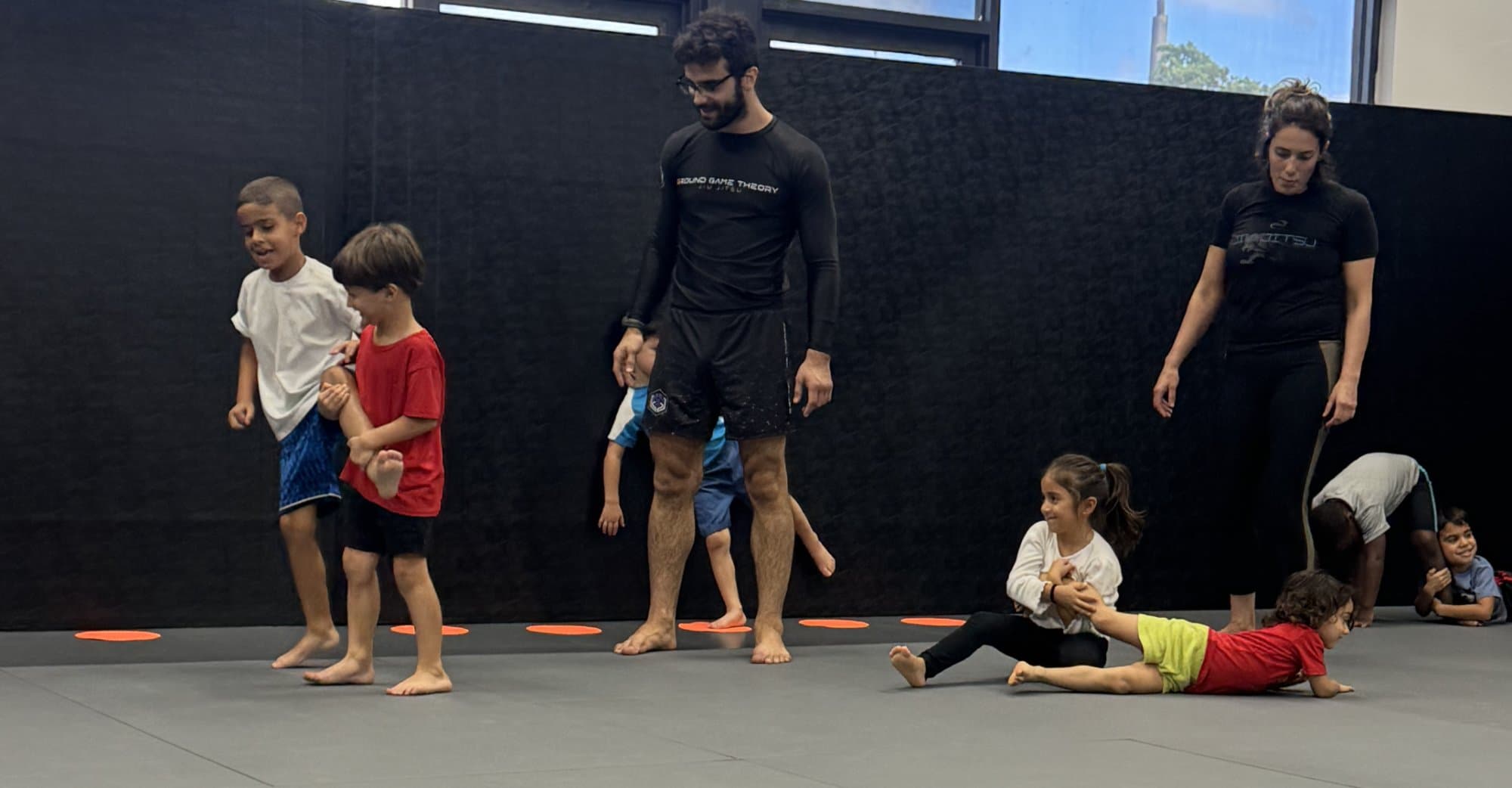 Kids Jiu Jitsu Class at Ground Game Theory Miami Kids participating in a beginner-friendly jiu jitsu class with coaches at Ground Game Theory in Miami, Florida.